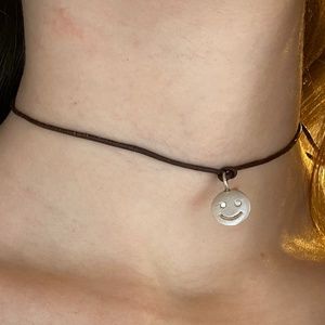 Black rope choker with smiley face